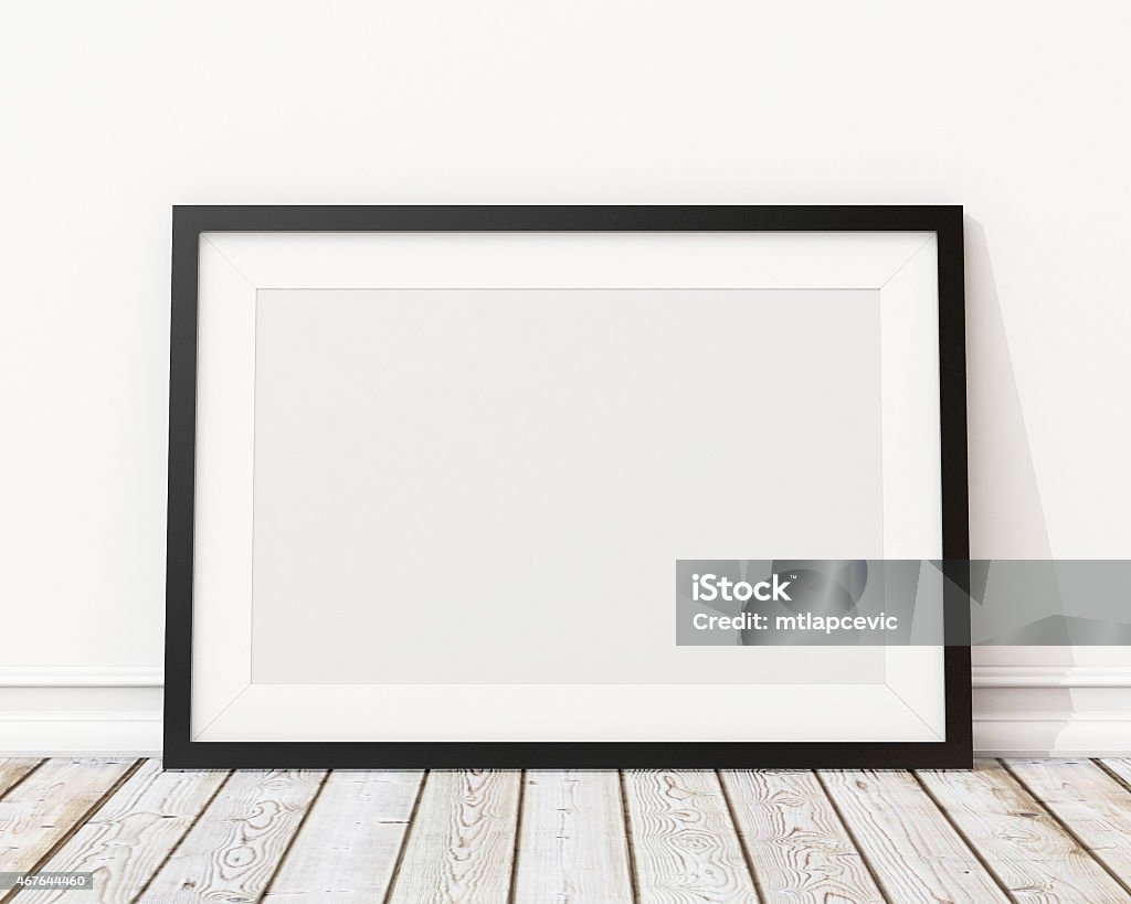 An empty black picture frame leaning against a wall blank black horizontal picture frame on the wall and the floorblank black horizontal picture frame on the wall and the floor Picture Frame Stock Photo