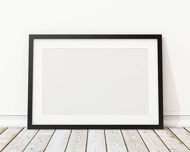 An empty black picture frame leaning against a wall blank black horizontal picture frame on the wall and the floorblank black horizontal picture frame on the wall and the floor leaning photos stock pictures, royalty-free photos & images
