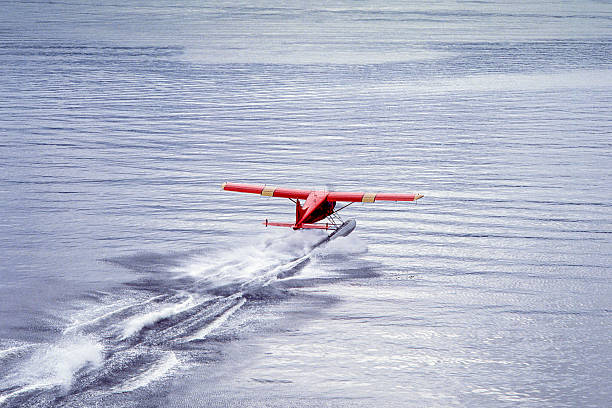 Alaskan float plane taking off in the Sitka, Alaska waterway.