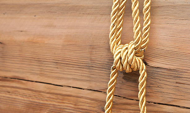 istock Gold knot on wooden background 467645673