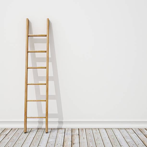 istock A wooden ladder against a white wall 467645976