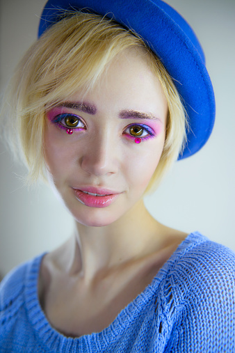 Fashion portrait of young beautiful girl with pink makeup and rhinestones