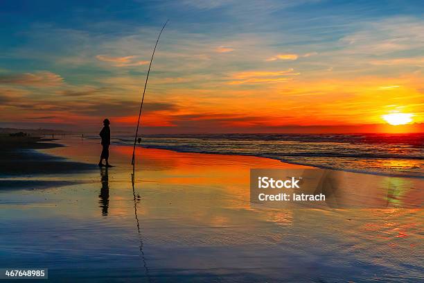 One Person Surfcasting At Sunset On The Beach Stock Photo - Download Image Now - Beach, Casablanca - Morocco, Fishing