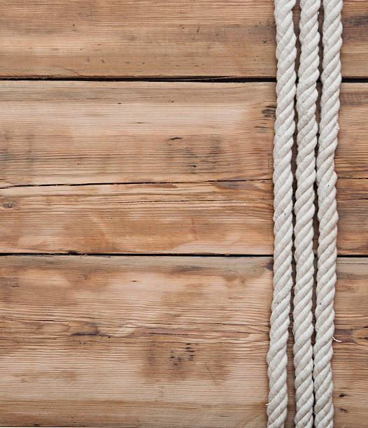 istock ship ropes on wooden background 467649355