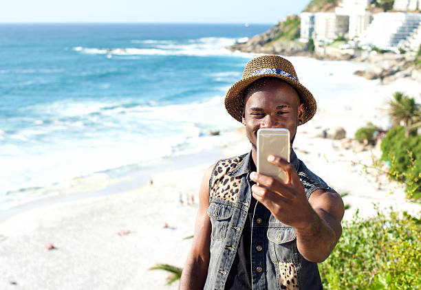 istock Happy african american man on vacation taking selfie 467651816