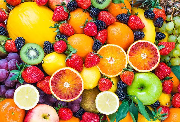 Fresh mixed fruits background.Organic fruits multicolore background.