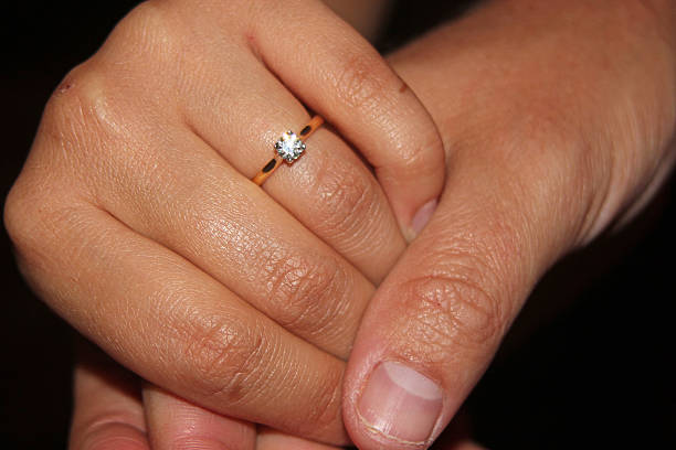 istock Close up of hands showing off an engagement ring 467653336