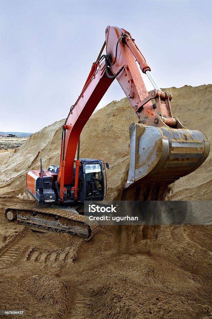 Mining Excavator working in a Mineral quarry. Backhoe Stock Photo