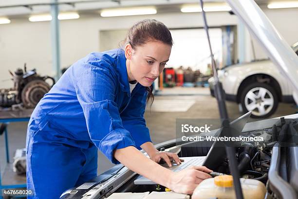 Mechanic Using Laptop On Car Stock Photo - Download Image Now - Laptop, Auto Mechanic, Car Hood