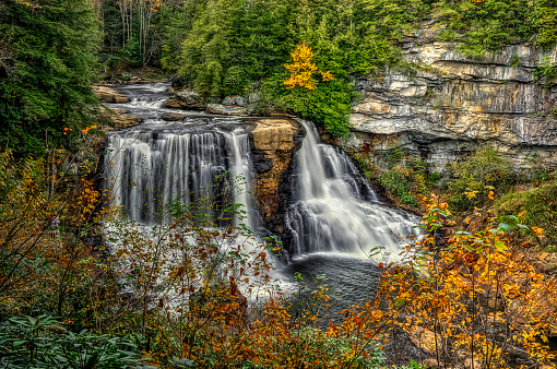 Beautiful fall foliage around Triple Falls in DuPont State Recreational Forest near Asheville North Carolina USA