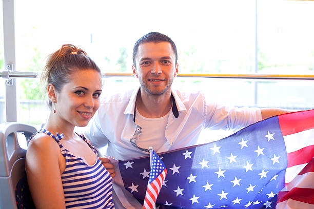 istock young couple with USA flag 467658655