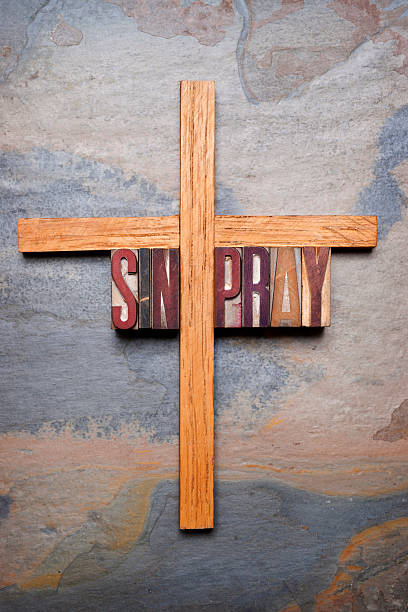 istock Christian Cross with Words PRAY and SIN 467658675