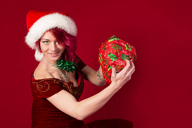 Triumphant Santa's elf with badly wrapped present.