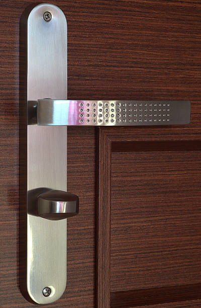istock Modern chrome handle on dark brown wooden door 467659382