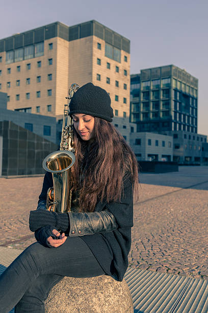 istock Beautiful young woman with her saxophone 467659568