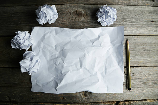 istock Crumpled up papers with a sheet of blank paper 467662780