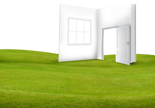 Book with open door on green grass and white background