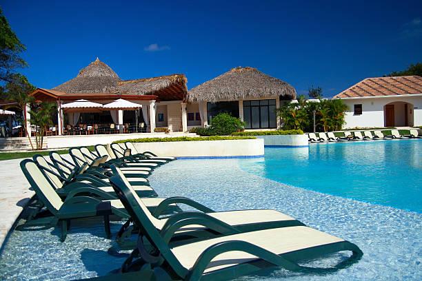 istock Chaise-longues in luxury swimming pool 467666941