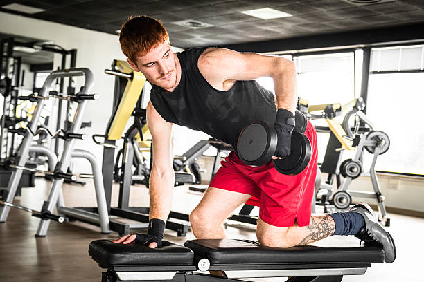 istock Red head man training with dumbell on gym 467668284