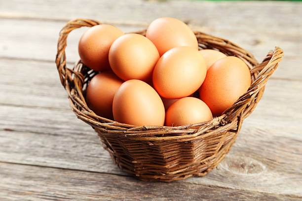 istock Chicken eggs in basket on grey wooden background 467668566