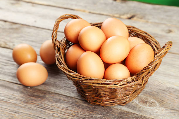 istock Chicken eggs in basket on grey wooden background 467668570