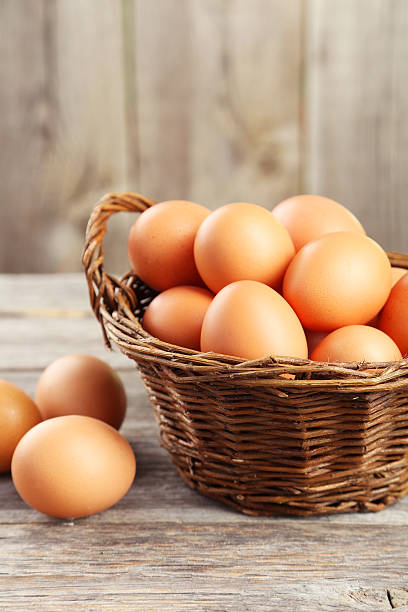 istock Chicken eggs in basket on grey wooden background 467668572