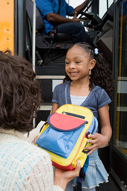 istock Girl Looking At Mother While Holding Backpack 467672330