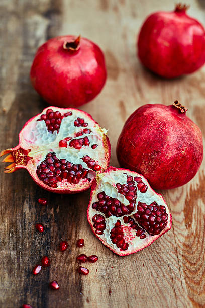 istock pomegranates on a dark wooden background 467674194