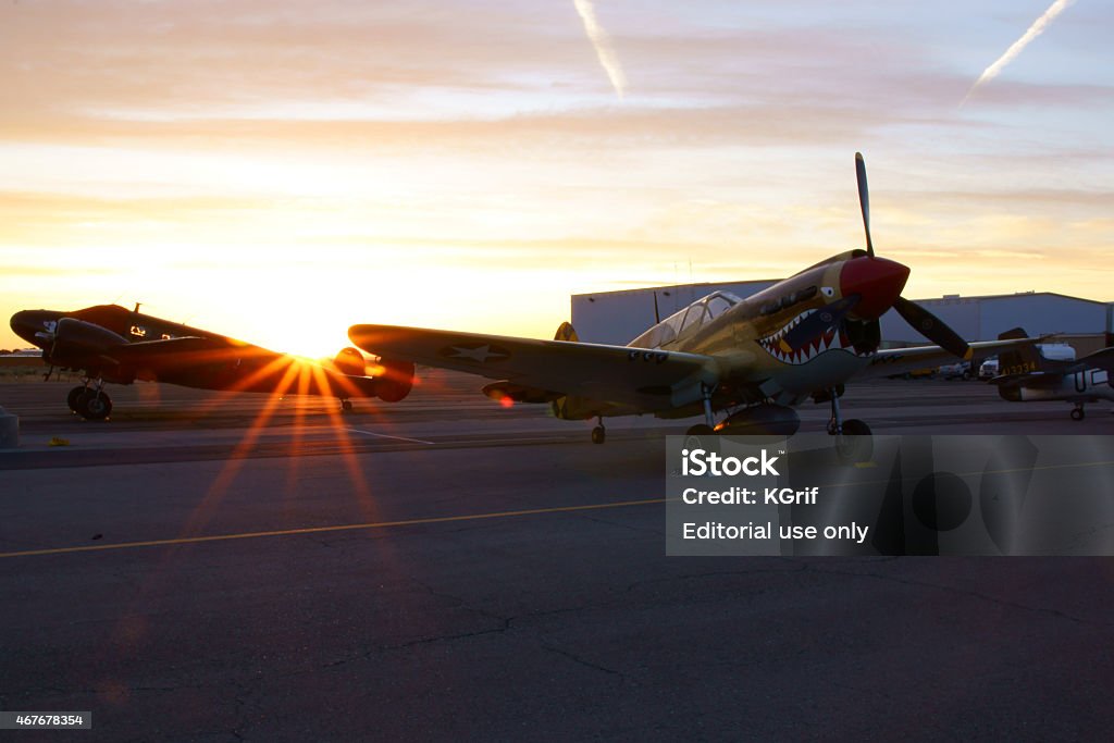 P-40 Warhawk Airplane sunrise at 2015 Los Angeles Air Show Los Angeles,California,USA- March 21,2015. P-40 Warhawk vintage WWII airplane at sunrise before the start of the 2015 Los Angeles Air Show at Fox Field, Lancaster,California. The 2015 Los Angeles Air Show features 2 days of military and civilian aircraft performing. The main event of each day was the US Air Force Thunderbirds flight demonstration squadron. 2015 Stock Photo