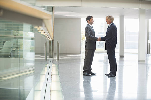 istock Confident Businessmen Shaking Hands In Office 467678678