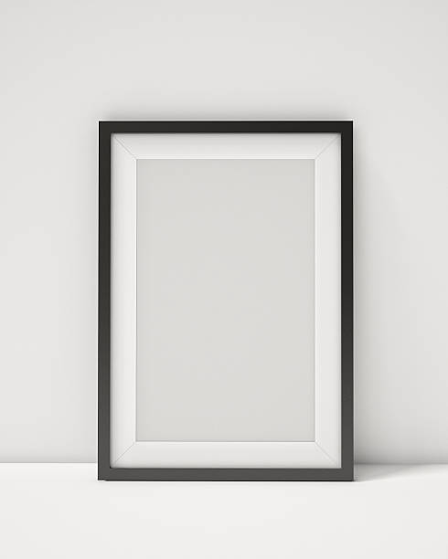 blank black picture frame on the white interior background - muur fotos stockfoto's en -beelden