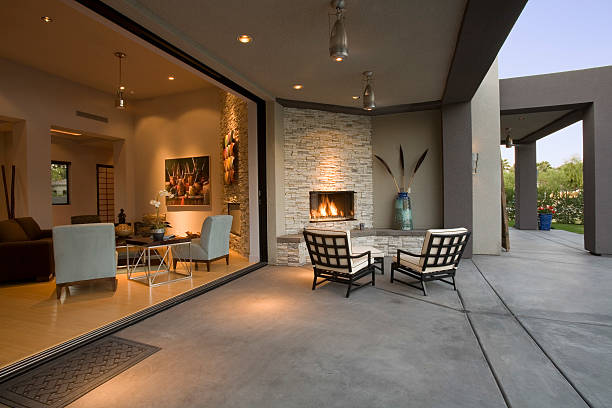 Chairs By Fireplace In Patio View of chairs by fireplace in patio of a modern home fireplace and armchair stock pictures, royalty-free photos & images