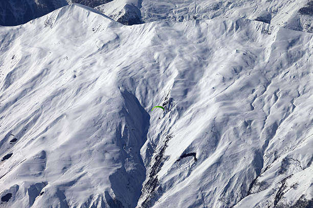istock Off-piste slope and paraglider in nice day 467694082