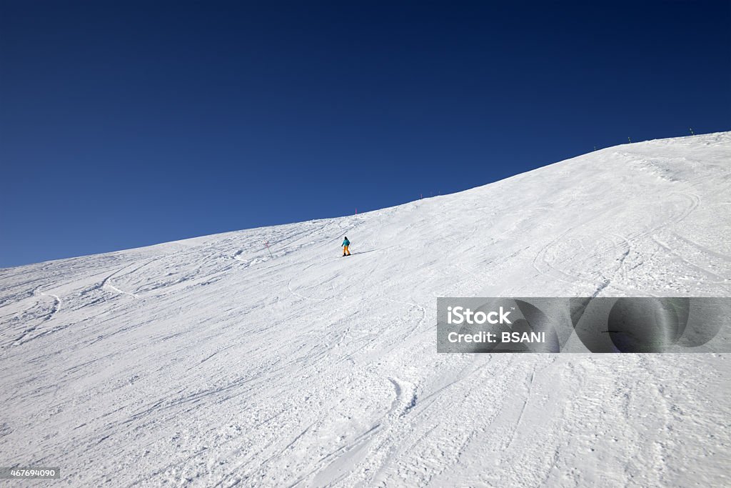 Skier on slope in sun day Skier on slope in sun day. Caucasus Mountains, Georgia. Ski resort Gudauri. 2015 Stock Photo