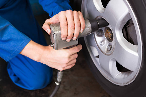 istock Mechanic adjusting the tire wheel 467698432