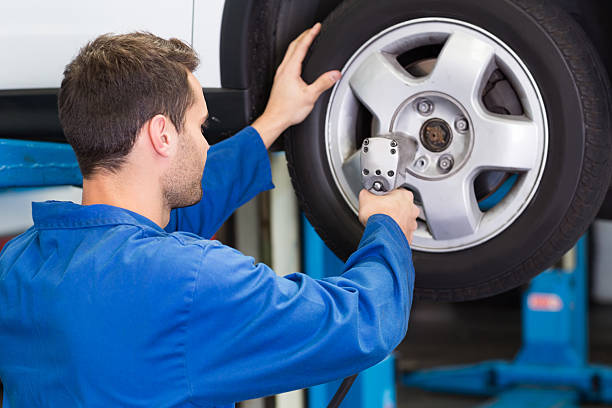 istock Mechanic adjusting the tire wheel 467698492