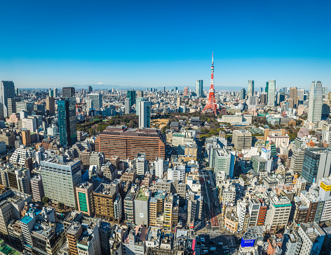 Clear blue skies above the crowded skyscraper cityscape of Tokyo, from the iconic snow capped summit of Mt. Fuji to the red and white spire of Tokyo Tower and the rooftops of Japan's vibrant capital city. ProPhoto RGB profile for maximum color fidelity and gamut.