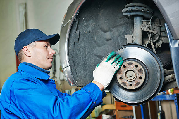 istock auto mechanic at car suspension repairing 467700268