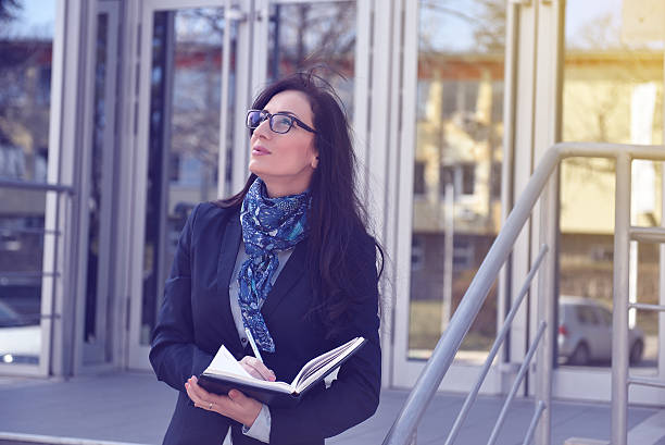 istock Businesswoman standing outside office building 467703246