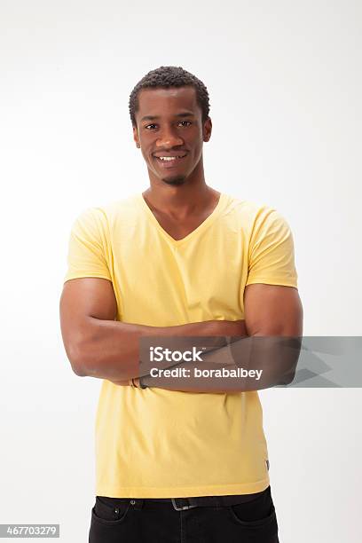 Happy Young Man With Crossed Arms On While Background Stock Photo - Download Image Now