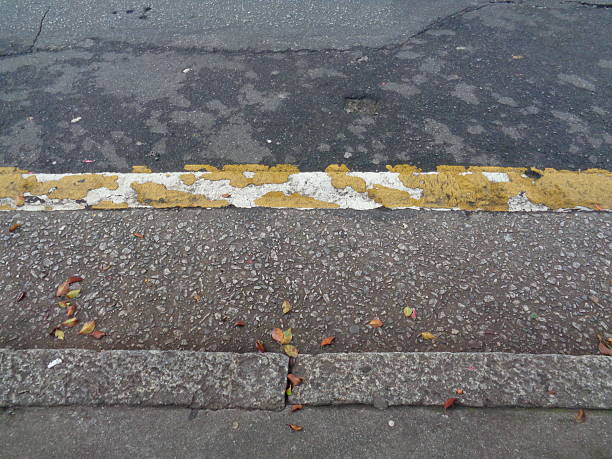 istock sidewalk and street with damaged guide 467703370