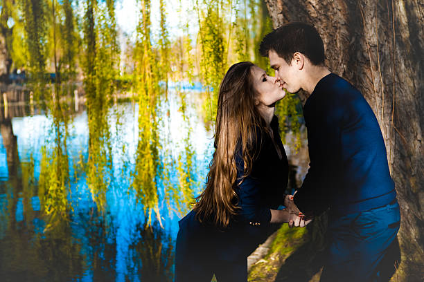 Free Stock Photo of Couple sharing a kiss amidst forest trees ...