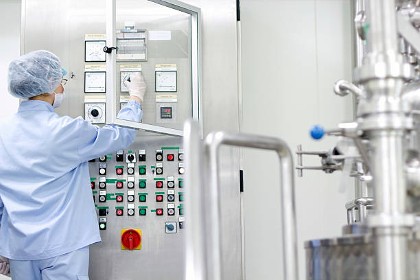 istock Worker in blue at pharmaceutical and medicine manufacturing, 467704421