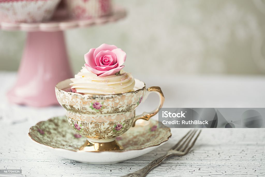 Cupcake in a vintage teacup Rose cupcake in a vintage teacup Tea Party Stock Photo