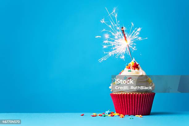 Cupcake With Sparkler On Blue Stock Photo - Download Image Now - Cupcake, Birthday, Birthday Cake