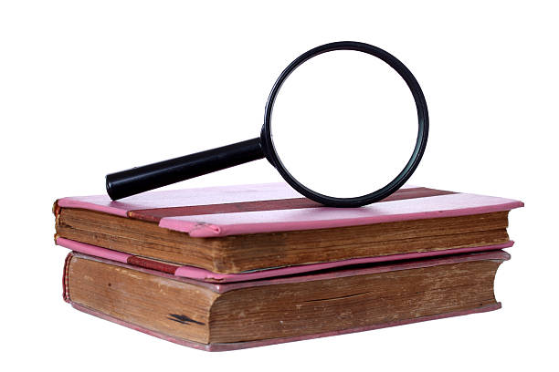 istock Magnifying glass and old book, isolated on white 467706557