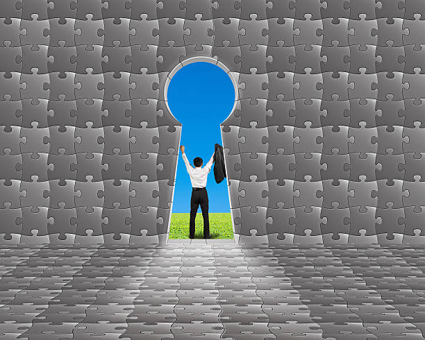 istock Cheered businessman outside puzzle building with key shape door 467707079
