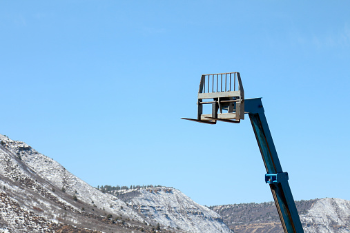 Fork lift that has a telescoping mechanism.  Equipment for material movement into high places.