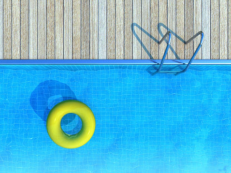 Geometric lines at the edge of a swimming pool with square mosaic pattern on floor. Marble frame. Crystal clear turquoise water background with idyllic liquid surface and wave pattern. Clean and transparent texture. Sunlight reflecting on ripples. Tropical summer vacation.
