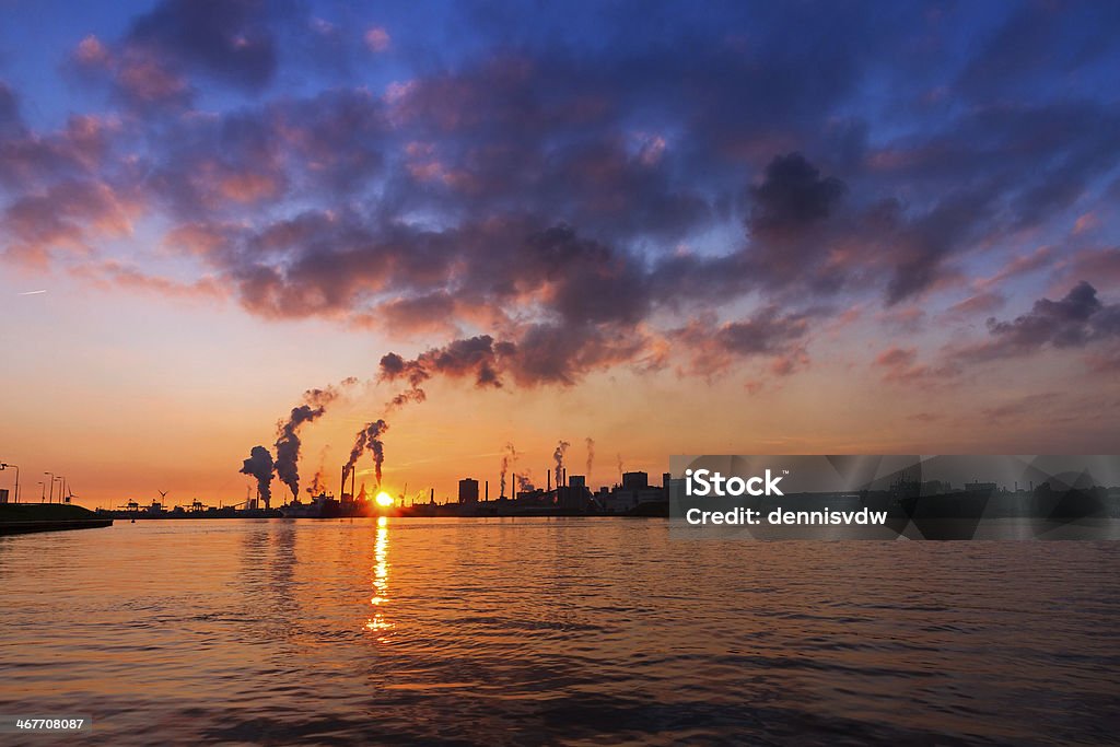 Vibrant industry Sunset view of the heavy industry with smoking chimneys in IJmuiden, the Netherlands. HDR Greenhouse Gas Stock Photo